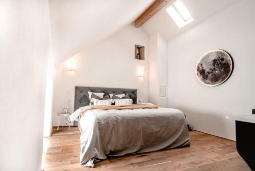 a bedroom with a large bed in a white room at Cloud 9 in Ralingen
