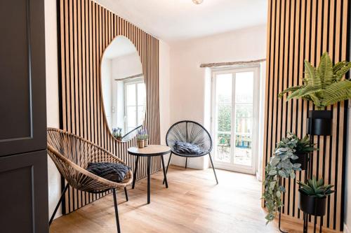 a room with two chairs and a table and a mirror at Cloud 9 in Ralingen
