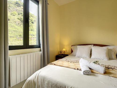 a bedroom with a bed with a window at Casa Avo Maria by Atlantic Holiday in São Vicente