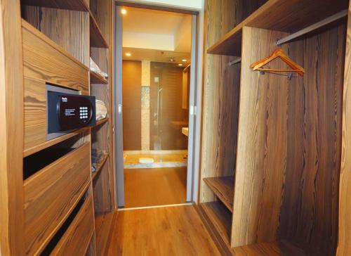 a bathroom with wooden walls and a walk in closet at Luxury Apartment at Corniche , Seaview Close Beach in Casablanca