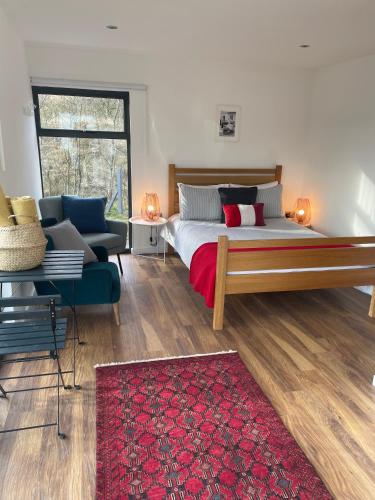 a bedroom with a large bed and a couch at Rossendale Holiday Cottages & Spa in Rossendale