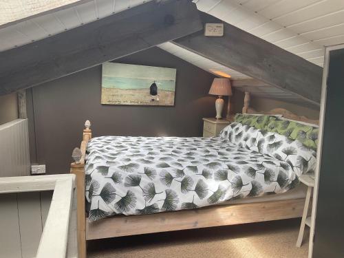 a bedroom with a bed in a attic at The Sawmill in Beaminster