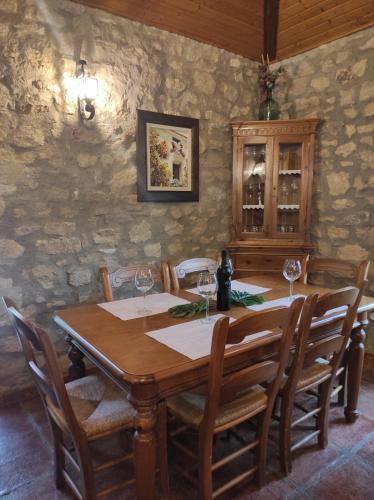 a dining room with a wooden table and chairs at Posada del Moral in Benaoján