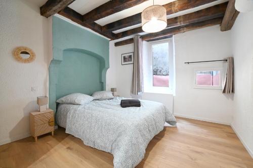 a bedroom with a large bed and a window at Maison avec spa dans l'hyper centre de Poitiers in Poitiers