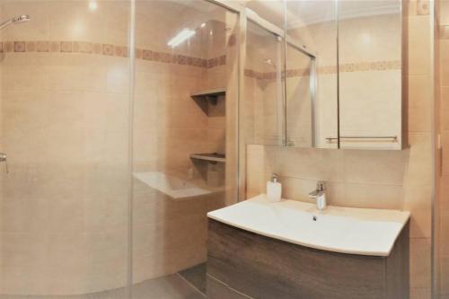 a bathroom with a sink and a glass shower at AMANE Lekeitio, Parking Incluido in Lekeitio