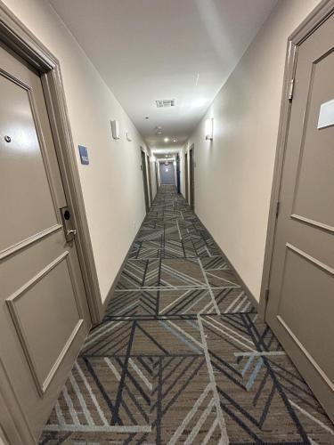 a hallway with a tile floor and an open door at Holiday Inn Express - Dallas Downtown by IHG in Dallas