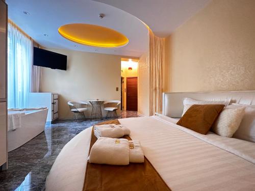 a bedroom with a large bed with a yellow ceiling at Hidden Bank: Pearls in Plovdiv