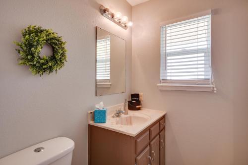 a bathroom with a sink and a mirror and a toilet at Pet-Friendly Vacation Rental with Yard in Canyon in Canyon
