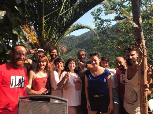 a group of people posing for a picture in the jungle at @gatetothewild in Coreglia Ligure