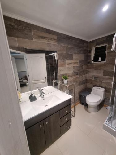 a bathroom with a sink and a toilet at Cabaña in Ancud