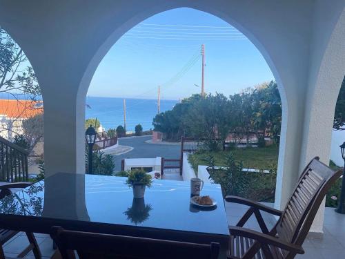 a room with a table and a view of the ocean at Nysa7 in Paphos City