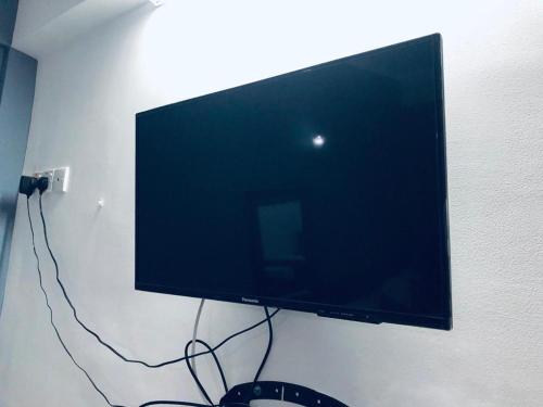 a flat screen tv hanging on a wall at Yal's Town Inn in Jaffna