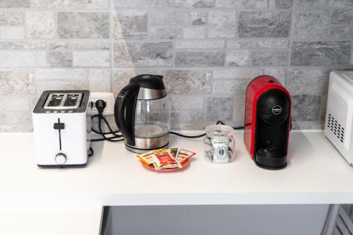 a counter with a coffee maker and a toaster at Viale della Repubblica free parking e Wifi 1 minute to Garda Lake in Peschiera del Garda
