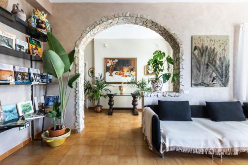 an archway in a room with a bed and plants at Dream House in Noto