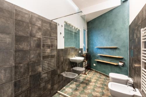 a bathroom with two toilets and a sink at Dream House in Noto