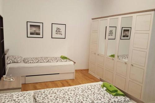 a bedroom with two beds and a large closet at Relax Apartment Vienna City Center in Vienna