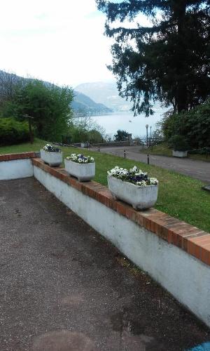 a row of concrete planters with flowers in them at Residenza del Pascià - Appartamento Camphora in Oggebbio