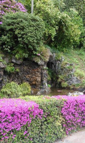 a garden with purple flowers and a stream at Residenza del Pascià - Appartamento Camphora in Oggebbio