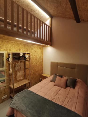 a bedroom with a large bed and a staircase at Linda House in Casais de São Mamede