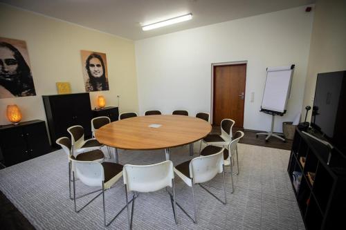 a conference room with a wooden table and chairs at Hindu Monastery - Shree Peetha Nilaya Ashram in Springen
