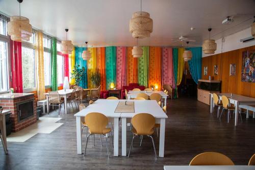 ein Restaurant mit Tischen und Stühlen und bunten Vorhängen in der Unterkunft Ashram Shree Peetha Nilaya in Springen