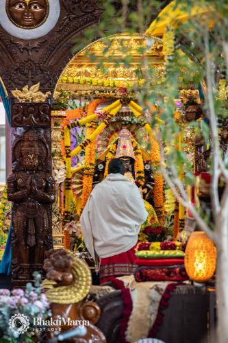a man standing in front of a altar in a temple at Hindu Monastery - Shree Peetha Nilaya Ashram in Springen