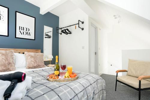 a bedroom with a bed with a tray of food on it at Central Buckingham Apartment #4 with Free Parking, Pool Table, Fast Wifi and Smart TV with Netflix by Yoko Property in Buckingham