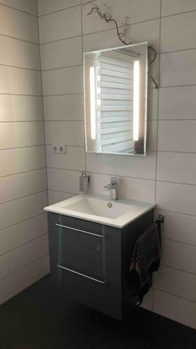 a bathroom with a sink and a mirror at Ferienhaus Ruhe Oase im Bayerischen Wald in Traitsching