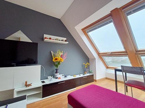 a living room with a flat screen tv on a wall at MARINA SOL VIVEIRO in Viveiro