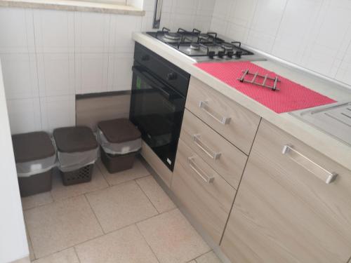a kitchen with a stove and a counter top at At home on the coast in Torre Santa Sabina