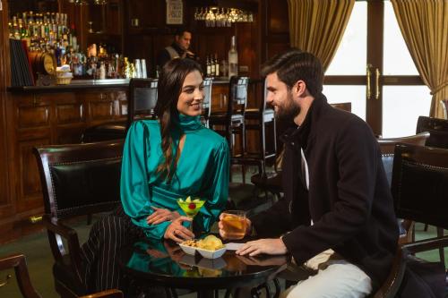a man and a woman sitting at a table in a bar at Country Club Lima Hotel – The Leading Hotels of the World in Lima