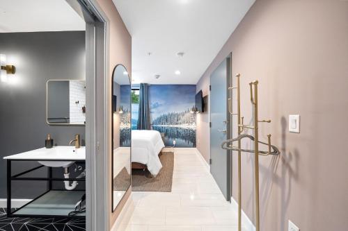 a bathroom with a sink and a bedroom at Wanderstay Boutique Hotel in Houston