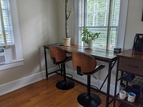 a wooden table with two chairs in a room at Sunny Efficiency In Historic Home in Durham
