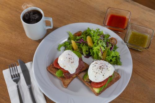 a plate of food with eggs on toast and a salad at Hotel 52 Playa del Carmen in Playa del Carmen