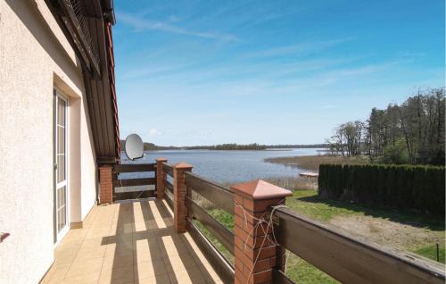 a balcony with a view of a body of water at 2 Bedroom Amazing Home In Bogaczewo in Bogaczewo