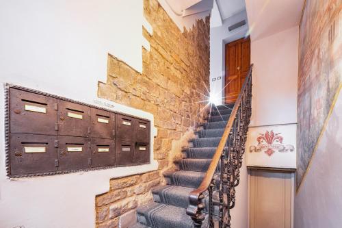 a staircase in a house with a brick wall at Condotta 16 Apartments in Florence