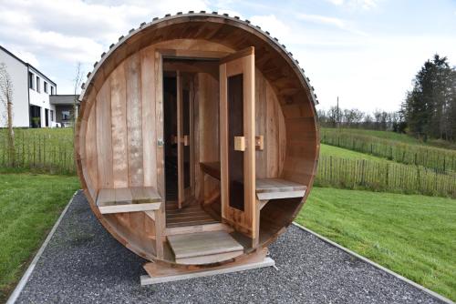 a barrel house is shown in a yard at Rochehaut, Les Semoiselles, Villa Isabelle in Bouillon