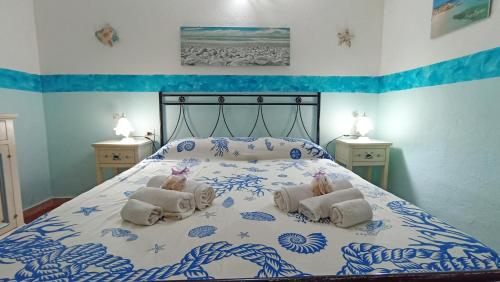 a bedroom with a bed with towels on it at Casa Vacanze VILLA SANDRINA in Costa Paradiso