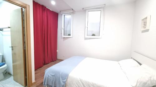 リスボンにあるCasa Intendenteのベッドルーム1室(ベッド1台、赤いカーテン付)