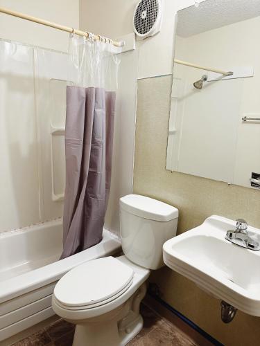 a bathroom with a toilet and a sink at Uptown Motel in Estevan