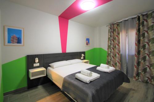 Un dormitorio con una cama con dos toallas encima. en CASATURIS NEWON APARTAMENTOS en EL CAMPELLO, en El Campello
