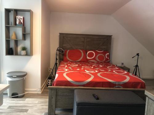 a bedroom with a bed with a red comforter at Private romantic apartment in fellspoint 2min from fellspoint night bars in Baltimore
