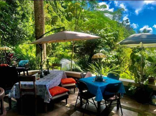 a patio with a table and chairs and an umbrella at ASRI Villas in Valencia