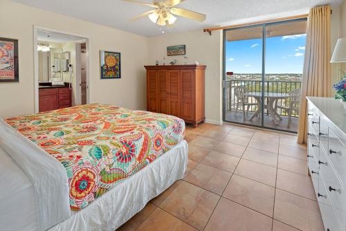 a bedroom with a bed and a balcony at Phoenix East 801 by ALBVR - Corner unit with wrap-around balcony and unparalleled views! in Orange Beach