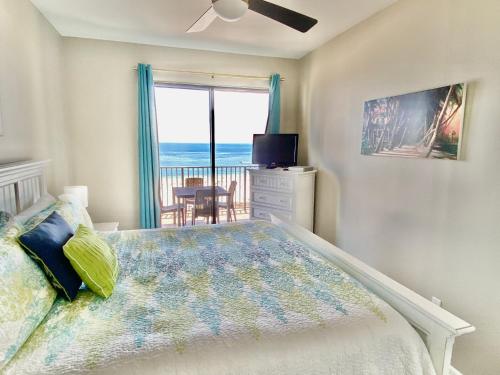 a bedroom with a bed and a view of the ocean at Phoenix VII 71113 by ALBVR - Beautiful Beachfront Condo with Amazing Views & Amenities! in Orange Beach