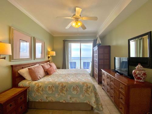 a bedroom with a bed with a ceiling fan and a television at Island Royale P403 by ALBVR - Beautiful Beachfront Penthouse Level Condo! in Gulf Shores