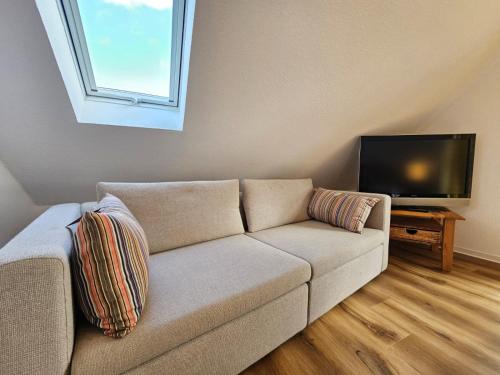 Televisyen dan/atau pusat hiburan di Ferienhaus Lupine