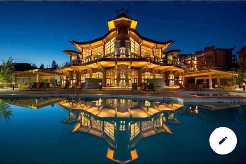 a large building with a pool in front of it at Stay In The Okanagan - Copper Sky, West Kelowna in West Kelowna