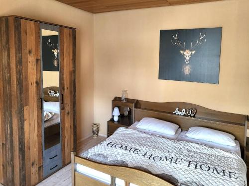 a bedroom with a bed and a deer head on the wall at Regal Apartment in Pracht with Garden and Grill in Pracht
