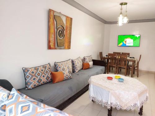 a living room with a couch and a table at apartment in centre ville in Rabat